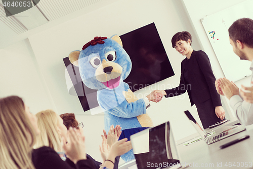 Image of boss dresed as bear having fun with business people in trendy of