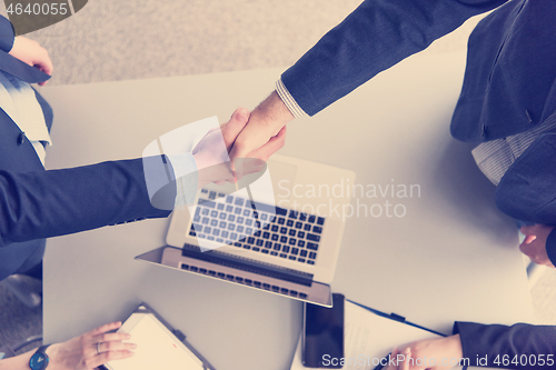 Image of cloasing the deal in modern office interior top view