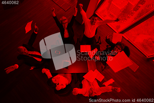 Image of top view of business people group throwing dociments in air