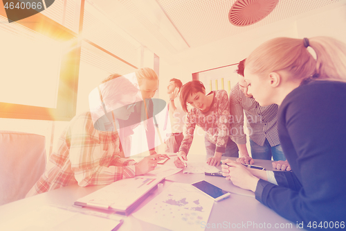 Image of startup business team on meeting at modern office with sunset in