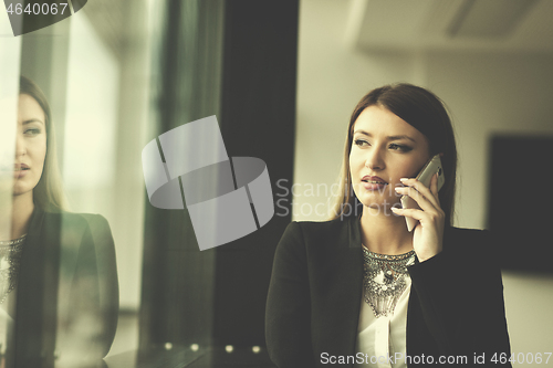 Image of Business Girl Standing In A Modern Building Near The Window With