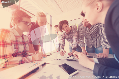 Image of startup business team on meeting at modern office with sunset in