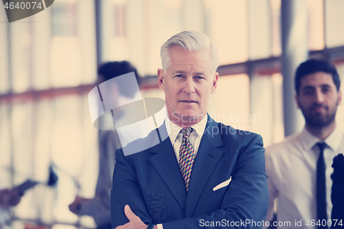 Image of portrait of handsome senior business man at modern office