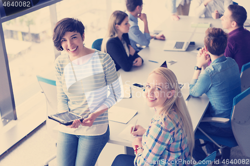 Image of Pretty Businesswomen Using Tablet In Office Building during conf