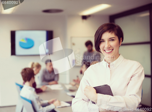 Image of hispanic businesswoman with tablet at meeting room