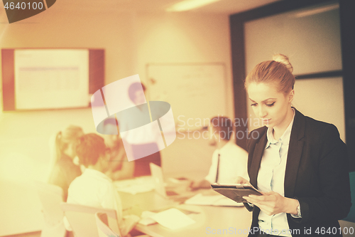 Image of business woman on meeting  using tablet computer