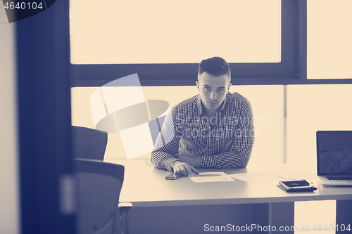 Image of young businessman at his desk in office