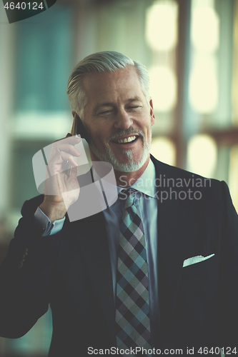 Image of senior business man talk on mobile phone