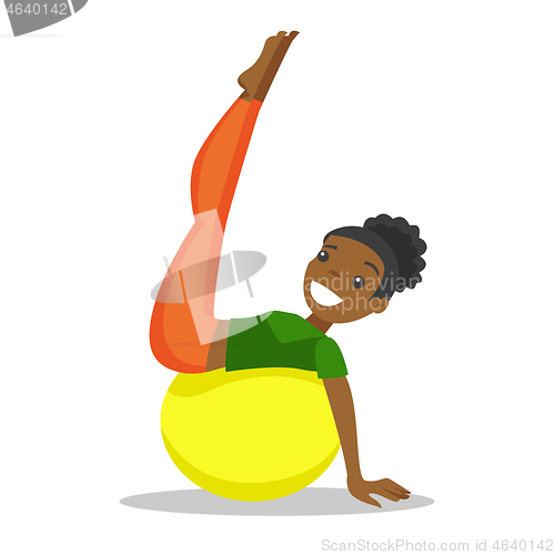 Image of African-american woman exercising with fit ball.