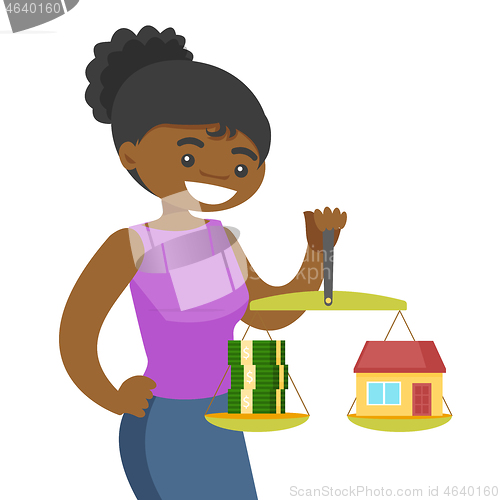 Image of Young woman holding scales with money and house.