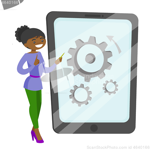 Image of African-american woman pointing at big tablet.