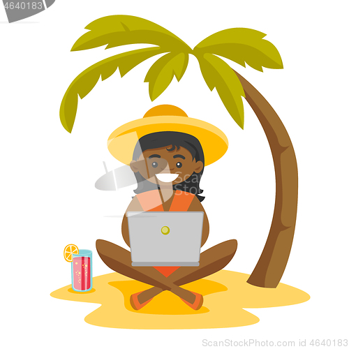 Image of Business woman working on a laptop on the beach.