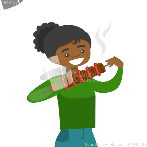 Image of Young african-american woman eating shashlik.