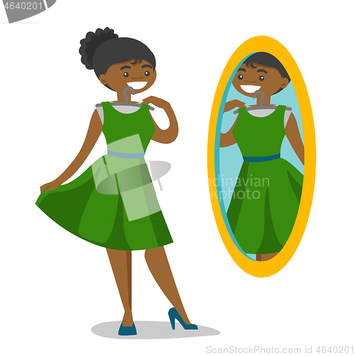 Image of Woman looking in the mirror in the dressing room.