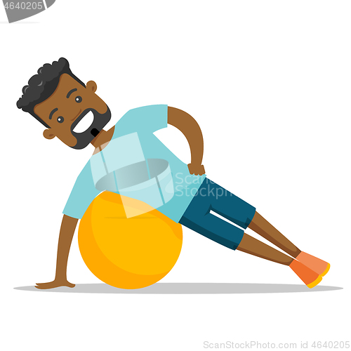 Image of Young african-american man exercising with fitball