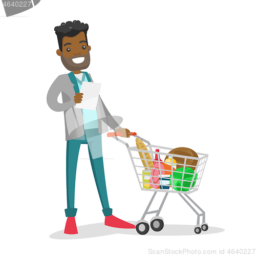 Image of Young african-american man checking shopping list.