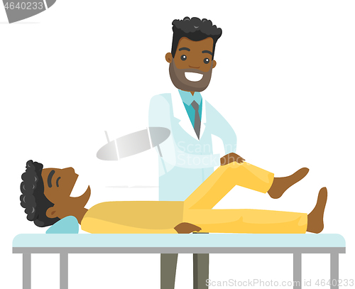 Image of African physio checking the leg of a patient.