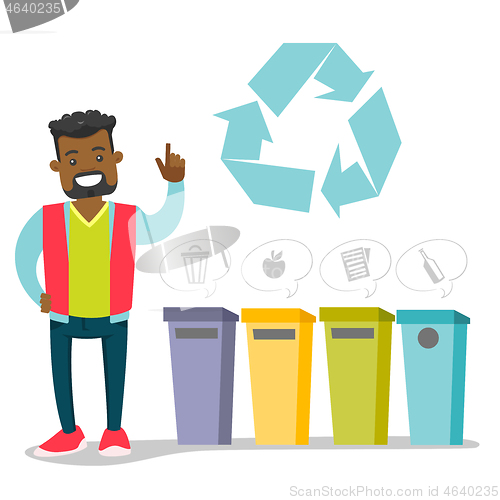 Image of African man standing next to the garbage bins.
