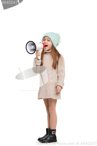 Image of Little cute kid baby girl holding in hand and speaking in electronic gray megaphone