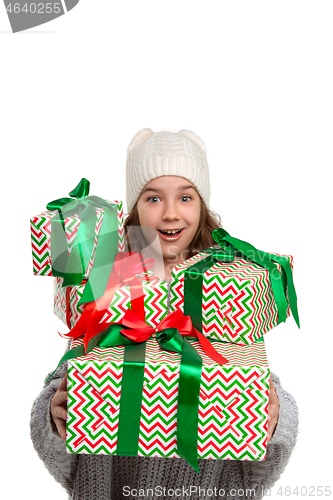 Image of Full length portrait of cute little kid in stylish knitted sweater looking at camera and smiling