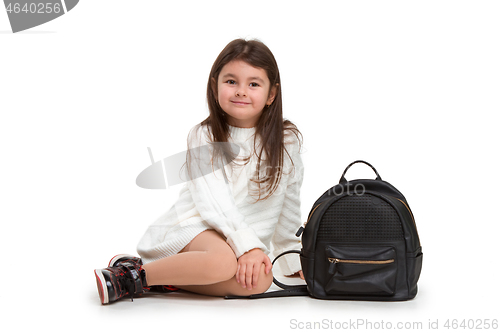 Image of portrait of cute little kid in stylish jeans clothes looking at camera and smiling