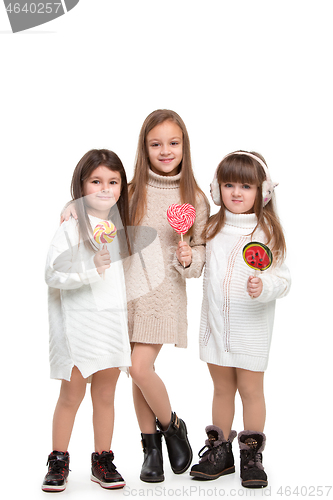 Image of portrait of cute little kids in stylish clothes looking at camera and smiling