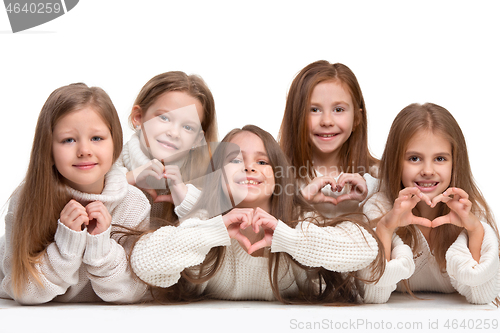 Image of portrait of cute little kids in stylish clothes looking at camera and smiling