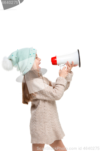 Image of Little cute kid baby girl holding in hand and speaking in electronic gray megaphone