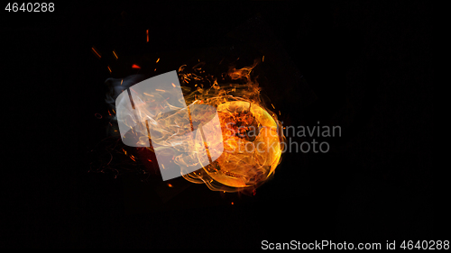 Image of Close-up soccer ball in fire on dark background