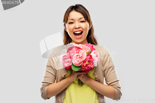 Image of happy asian woman with bunch of flowers