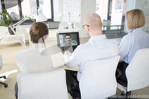 Image of business team having video conference at office