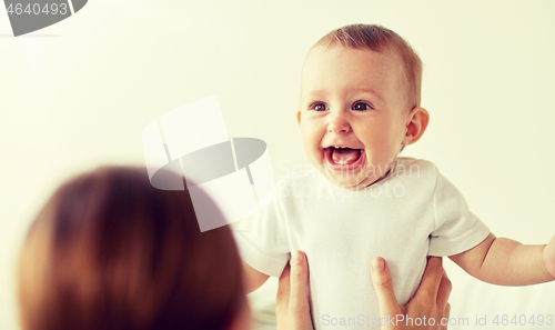 Image of happy little baby with mother at home