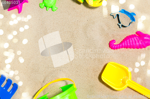 Image of close up of sand toys kit on summer beach