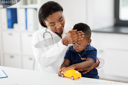 Image of doctor with measuring baby\'s temperature at clinic