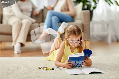 Image of student girl with textbook learning at home