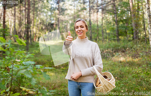 Image of woman with basket of mushrooms in forest