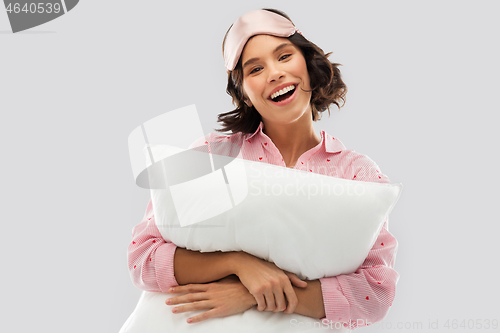 Image of woman with pillow in pajama and eye sleeping mask