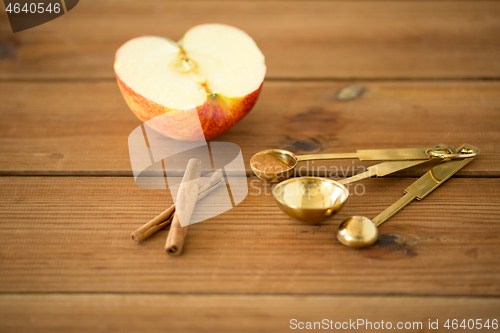 Image of half apple and knife on wooden cutting board