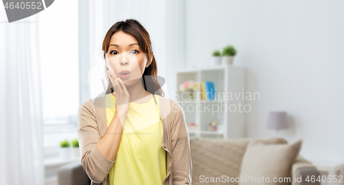 Image of surprised asian woman at home