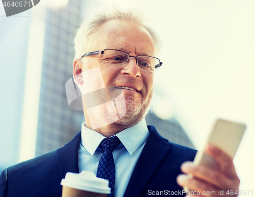 Image of businessman with smartphone and coffee in city