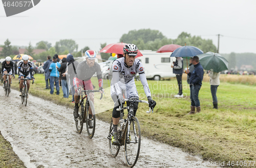 Image of Group of Cyclists on a Cobblestone Road - Tour de France 2014