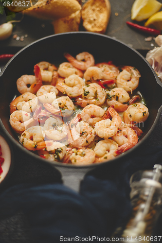 Image of Tasty shrimp tails fried in butter with, garlic, parsley, white wine chili. With various ingredients