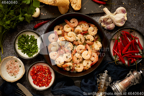 Image of Tasty shrimp tails fried in butter with, garlic, parsley, white wine chili. With various ingredients