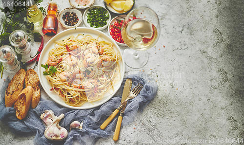 Image of Seafood concept. Pasta with shrimps in a plate, close-up, copy space, top view, flat lay.