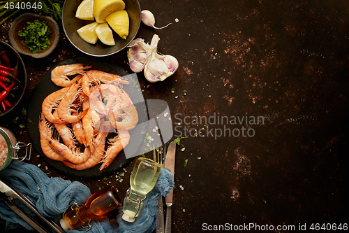 Image of Seafood composition with shrimps or prawns. Seved on dark background with many ingredients. Flat lay