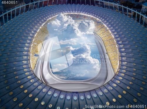 Image of View of stadium structure with porthole and clouds.