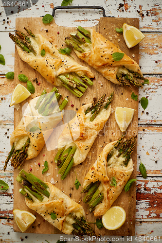 Image of Grilled green asparagus and cheese puff pastry folded as envelope and topped with black sesame