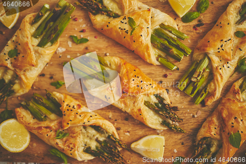Image of Grilled green asparagus and cheese puff pastry folded as envelope and topped with black sesame