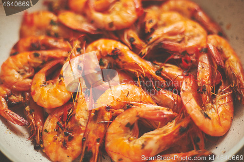Image of Close up of tasty fried whole prawns with parsley sprigs and garlic. Delicious seafood concept