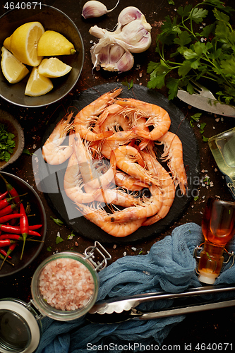 Image of Fresh and raw big shrimps ready to be prepared. With various ingredients on side